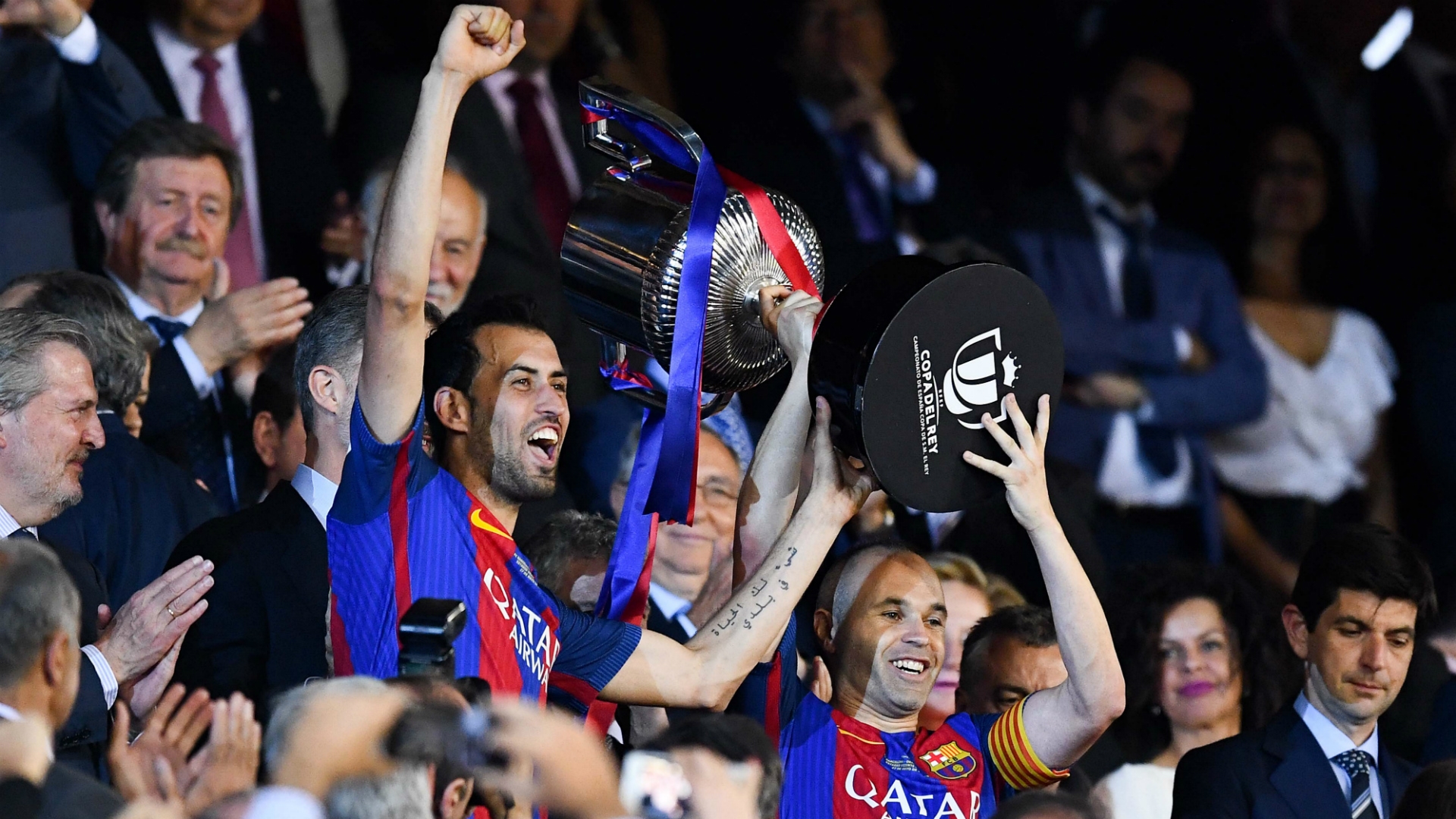 Iniesta and Busquets lifting Spanish Cup trophy