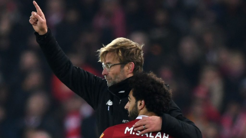 Jurgen Klopp and Salah celebrate. Pep Guardiola insists that title race is not yet over